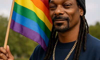 Snopp holding rainbow flag
