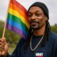Snopp holding rainbow flag